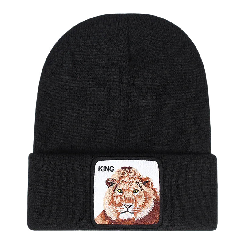 Ribbstickad svart mössa med lejon på och texten KING